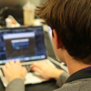 Technica participant typing on a laptop