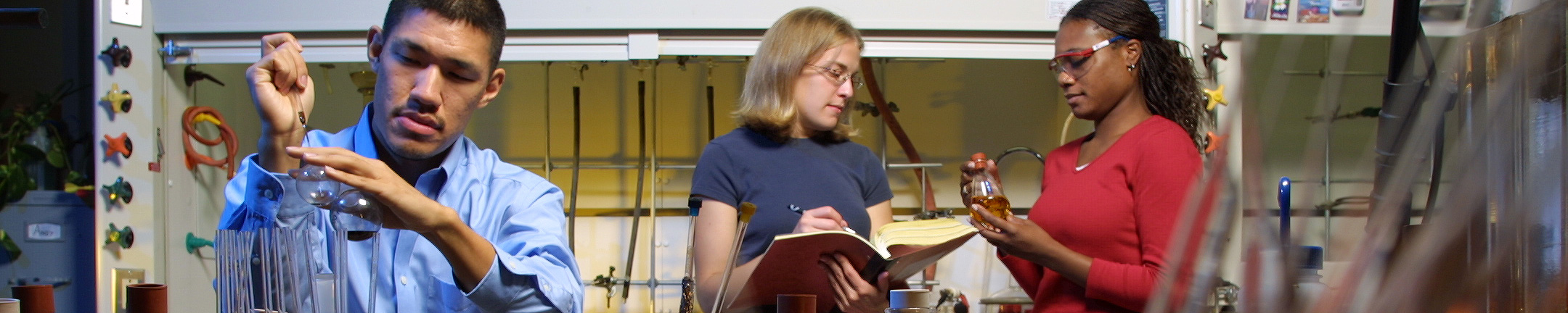 A man and two women in a wet lab.